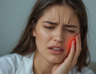 Woman with severe toothache holding cheek, dental emergency pain