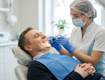 Patient relaxed during dental implant procedure with dentist ensuring comfortable and pain-free treatment